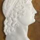 Profile of a young man in the style of antique marble.