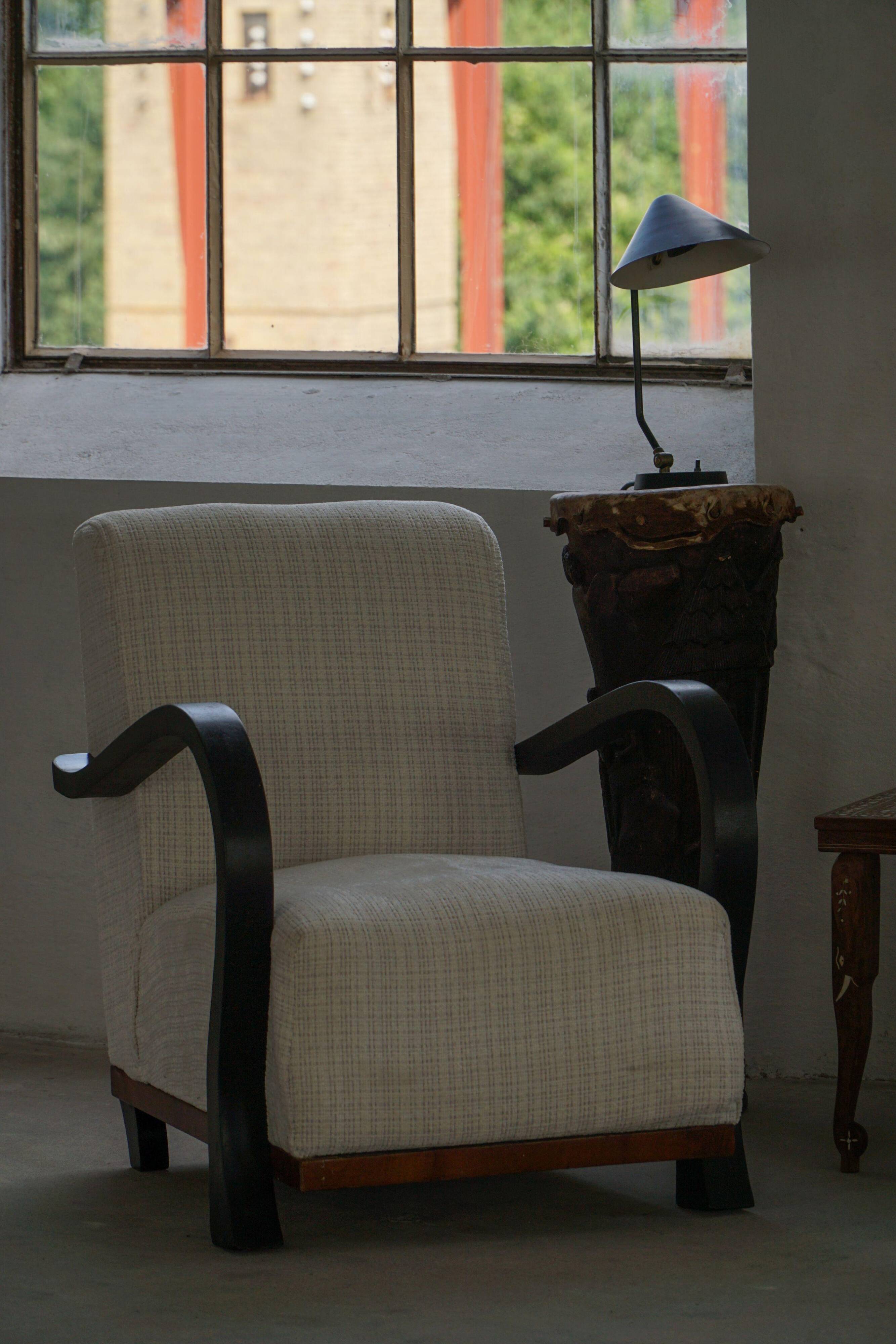 A pair of Swedish Art Deco lounge chairs with curved armrests, 1930s.