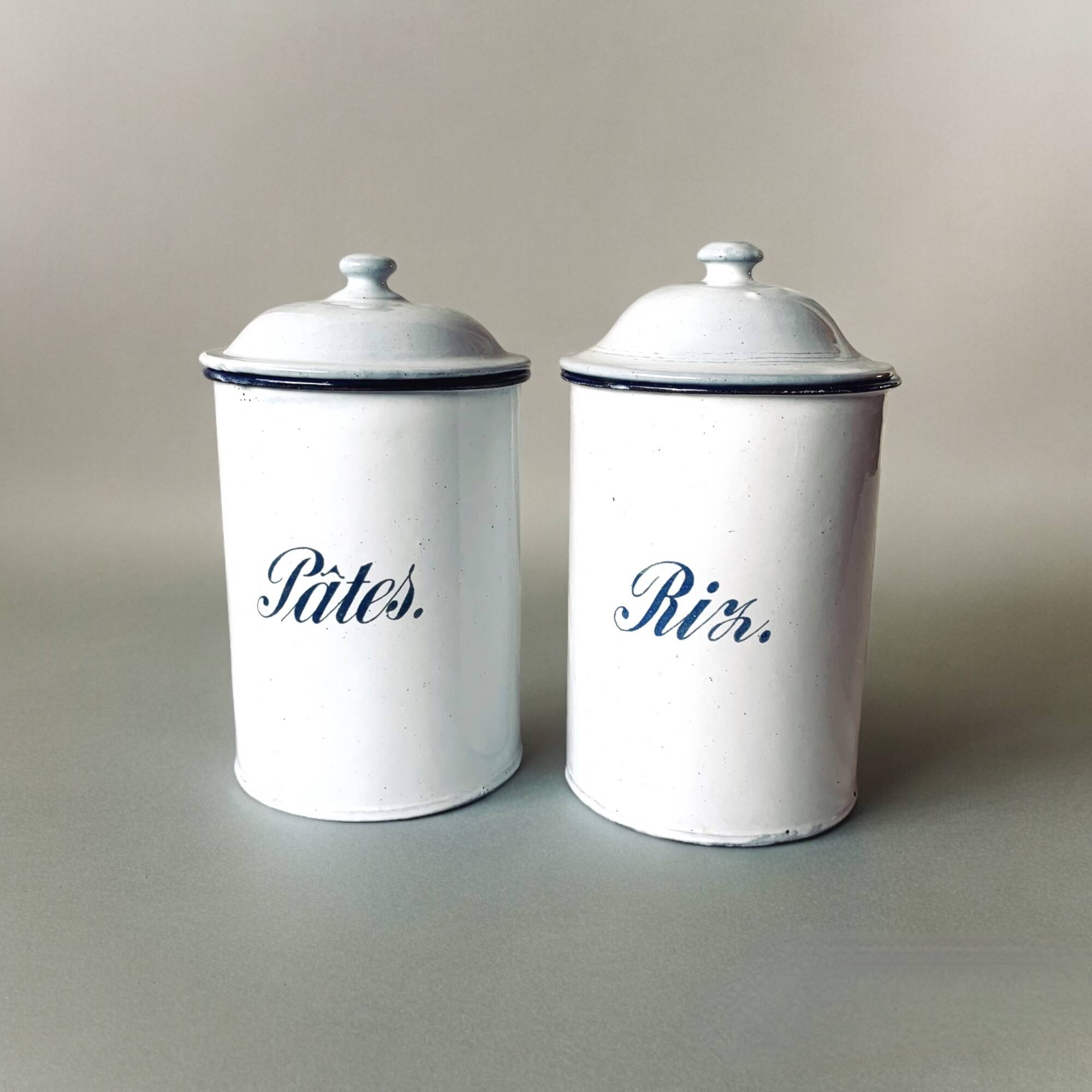 Pair of old large enameled sheet metal condiment pots