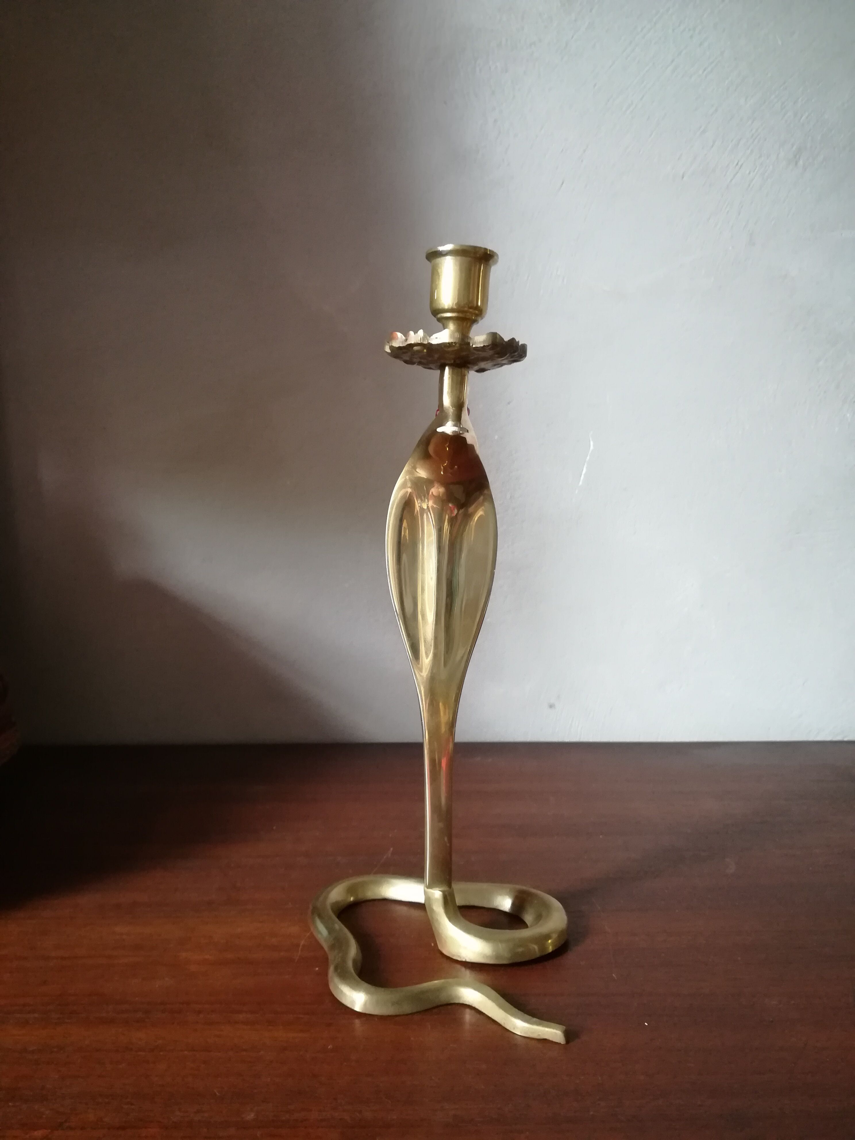 Candlestick mounted on brass cobra