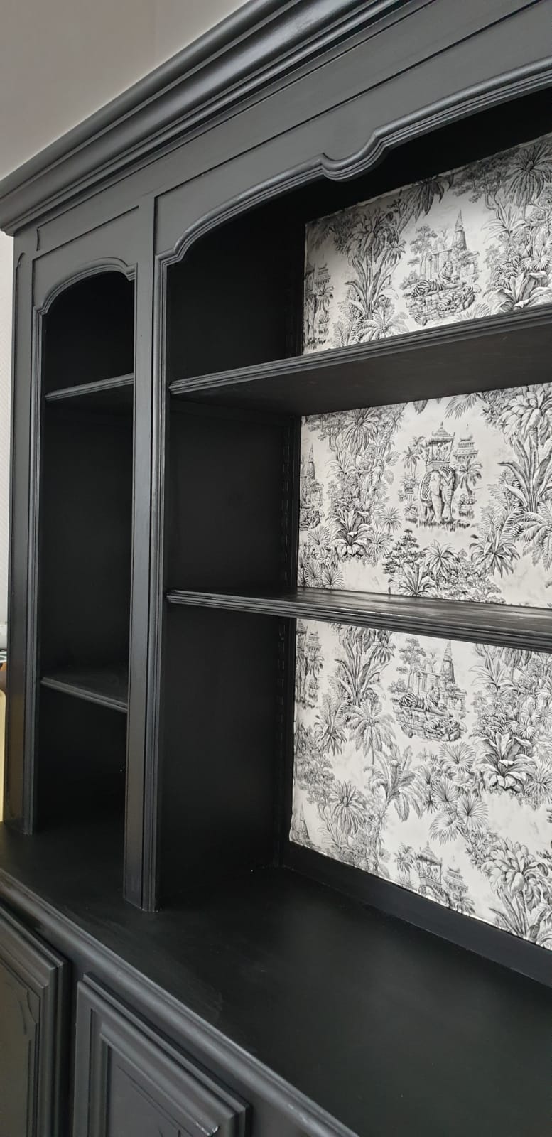 Oak bookcase black matte background dressed ouatine and junggle fabrics