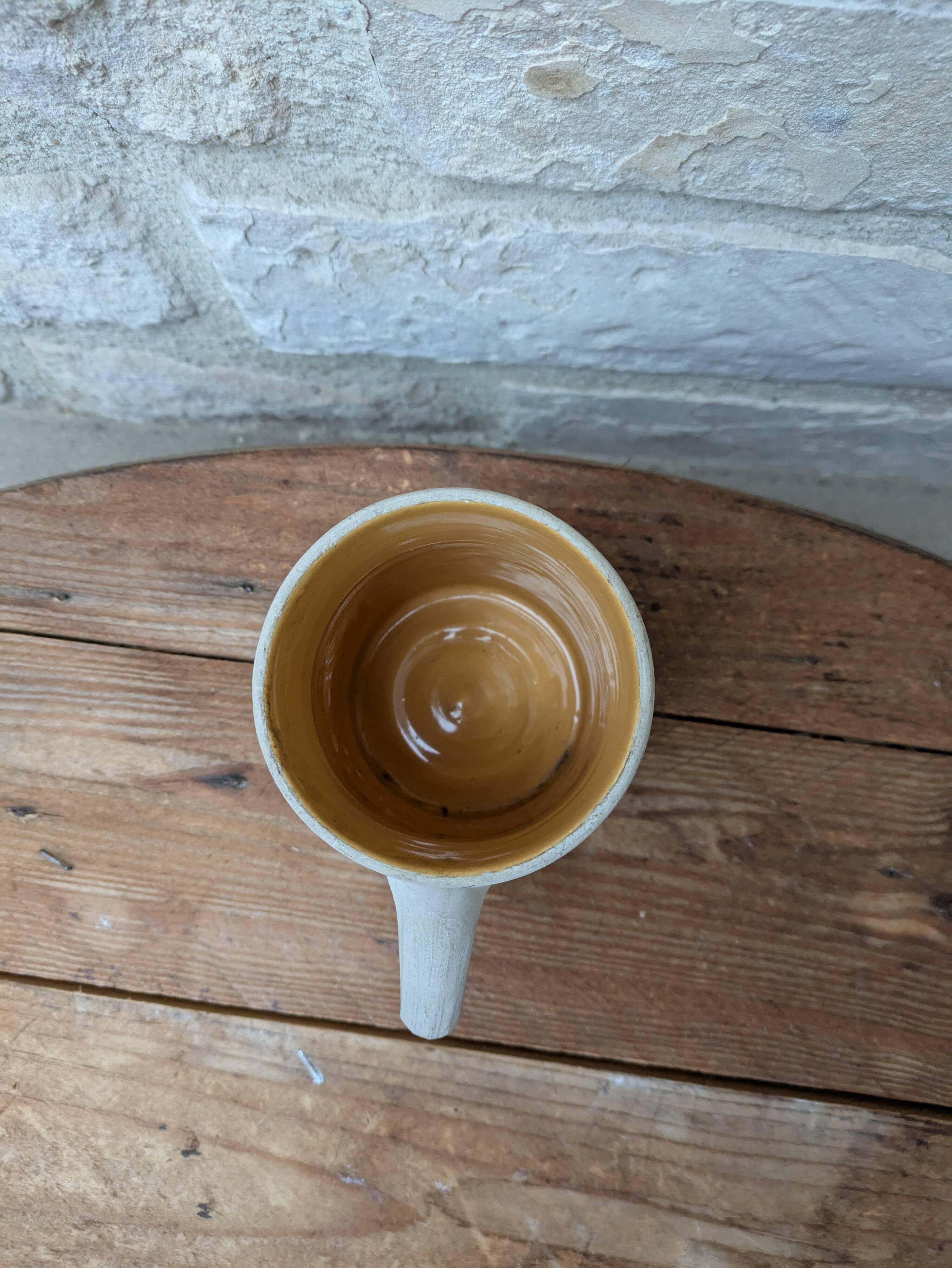 Old terracotta mug with glazed interior