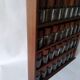 Wooden shelf with 32 vintage Cole & Mason spice jars