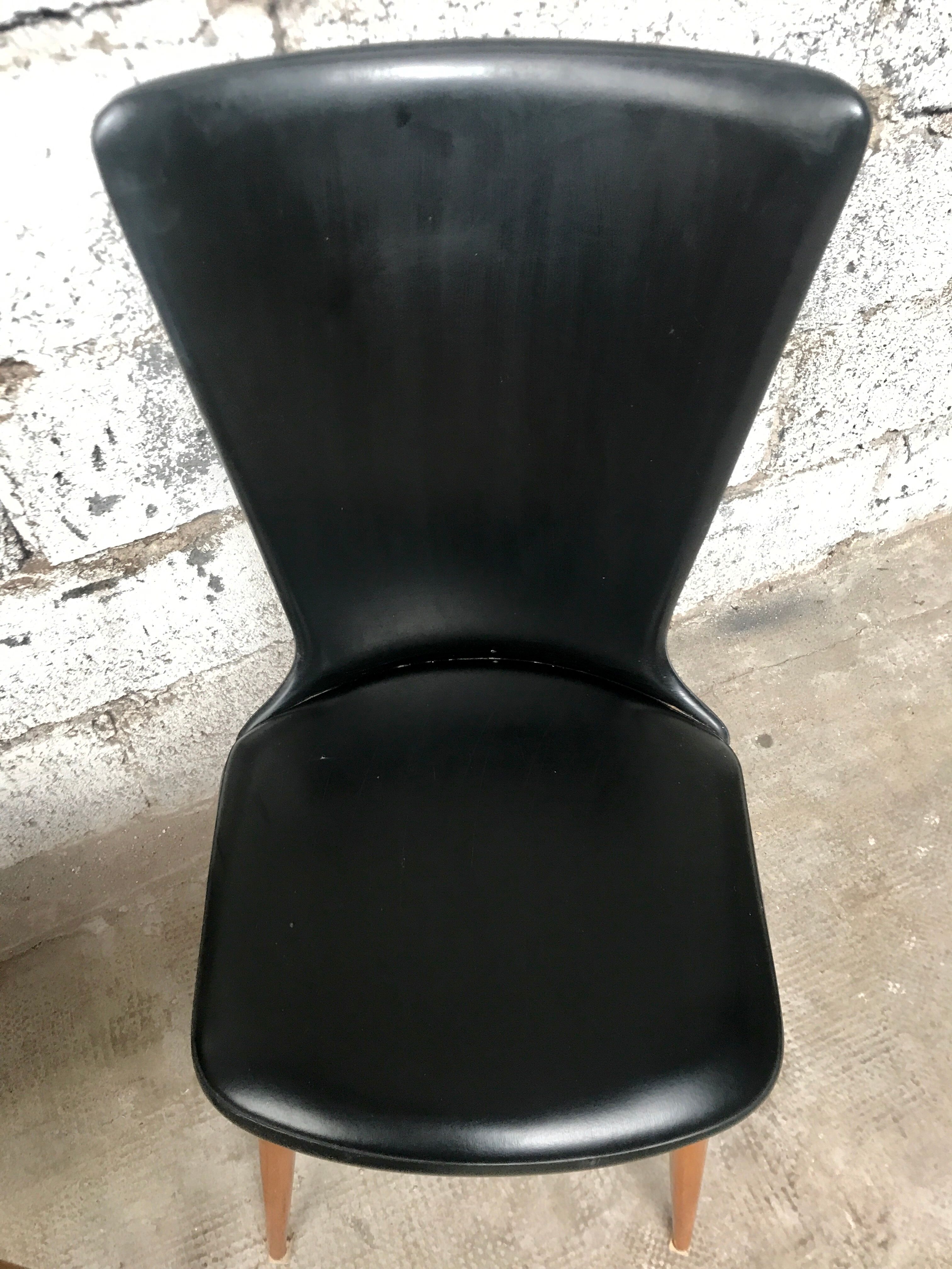 Pair of Baumann model Essor chairs in faux black leather, beech compass footing
