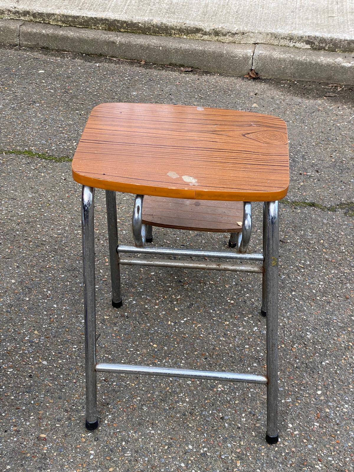 Folding stool in formica with a wood effect.