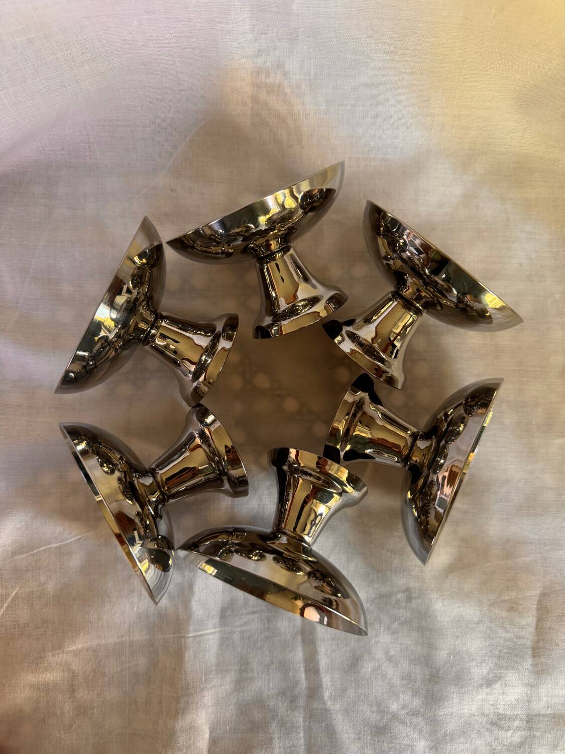 Set of 6 stainless steel ice cream bowls by Guy Degrenne with matching spoons.