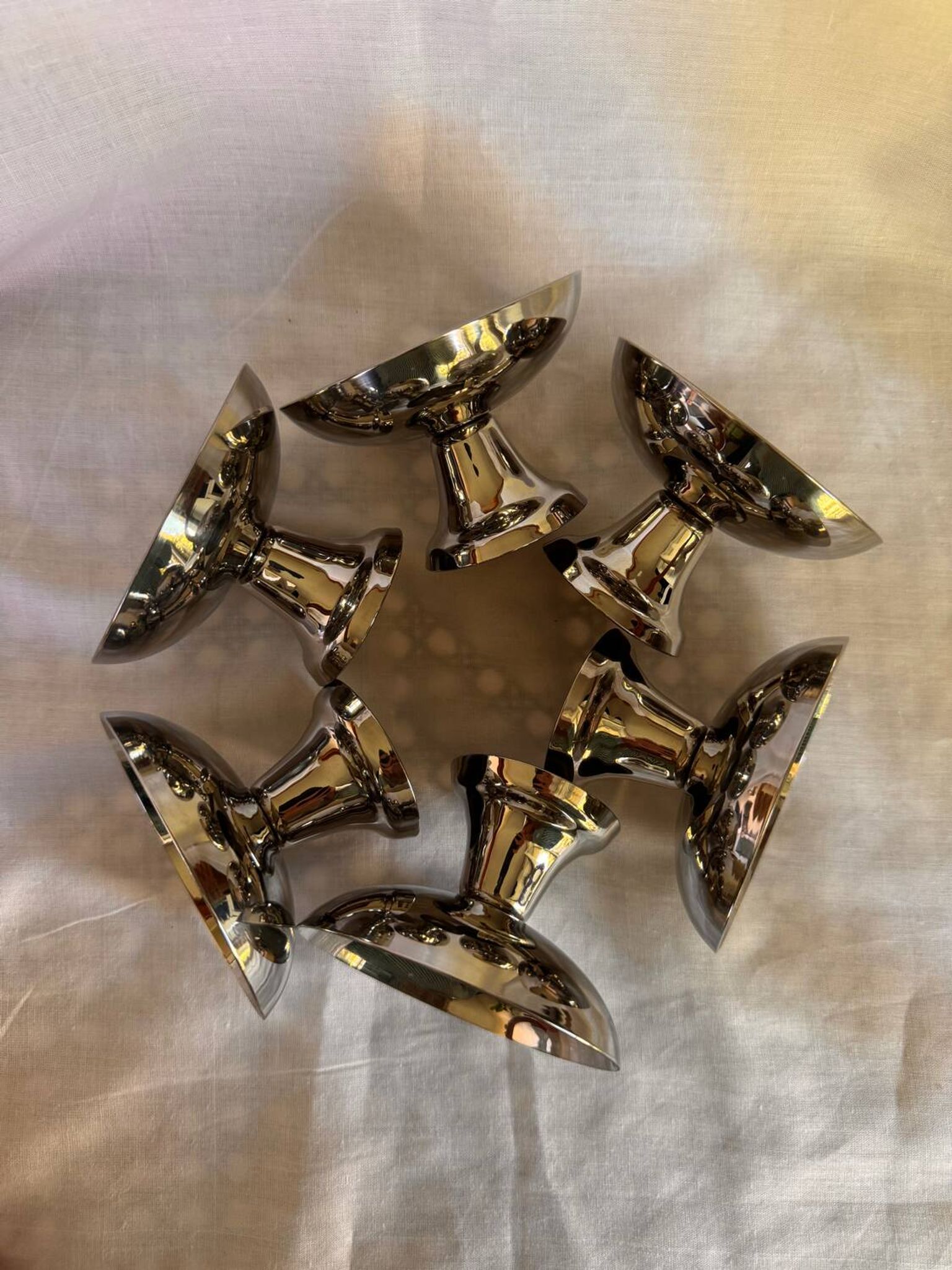 Set of 6 stainless steel ice cream bowls by Guy Degrenne with matching spoons.