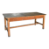 Large industrial workshop table in brown wood, wide top and sturdy vintage legs.