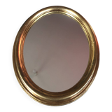 Golden oval mirror