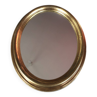 Golden oval mirror