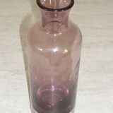 Plum-colored glass bottle with bubble