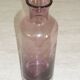 Plum-colored glass bottle with bubble