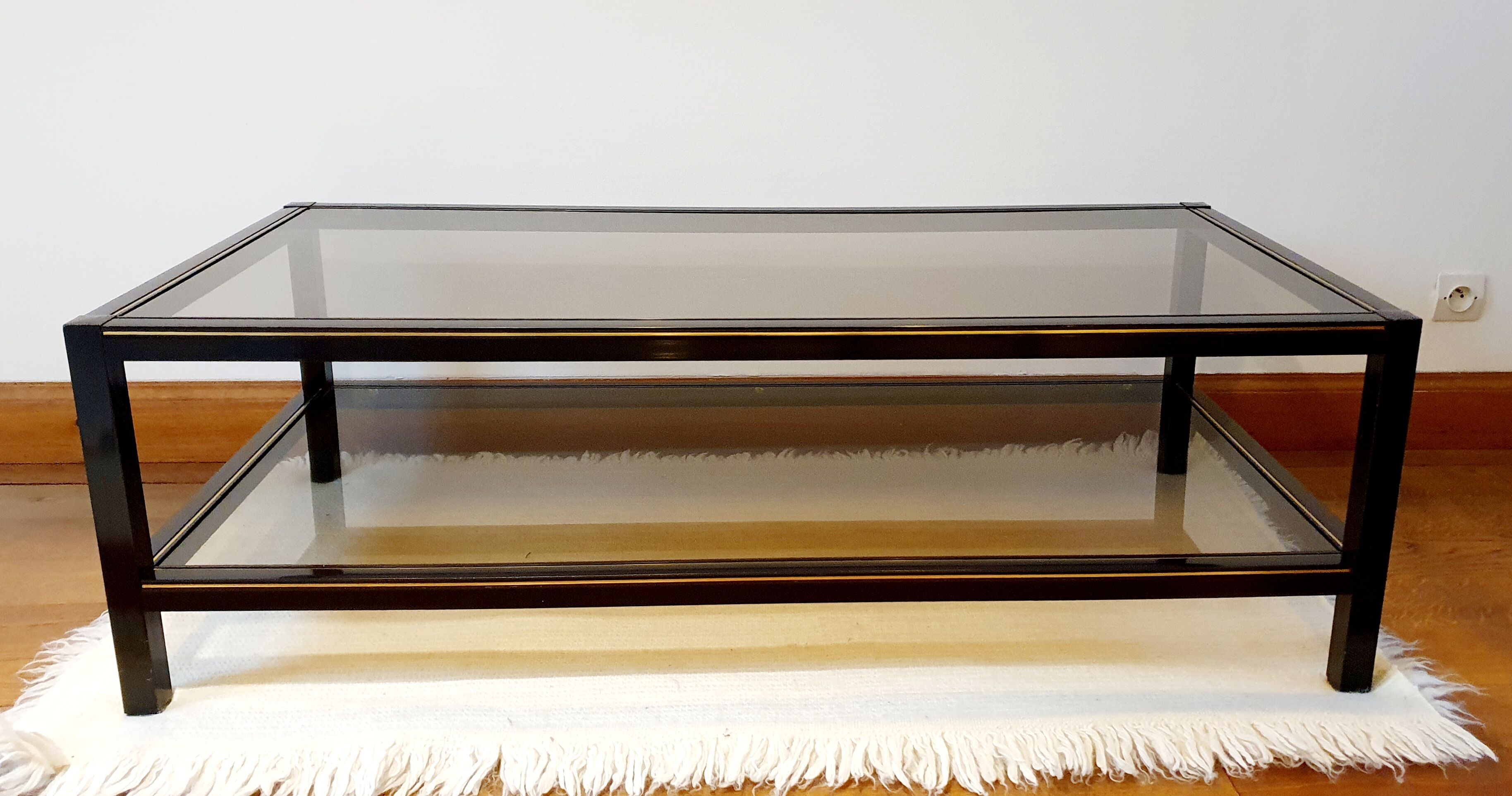 Black and gold coffee table with a double smoked glass top