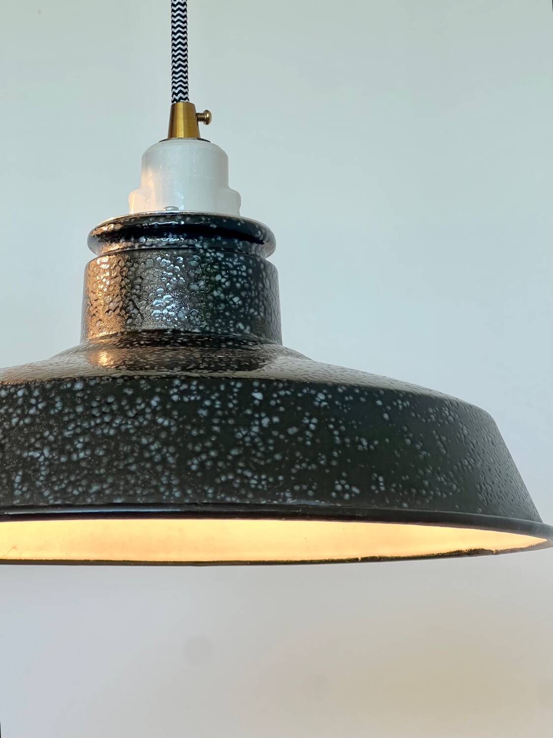 Pair of black and white industrial pendant lights with ceramic sockets