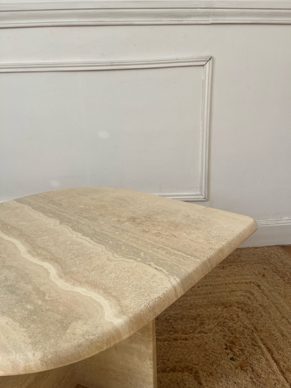 Travertine coffee table in eye shape.