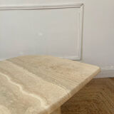 Travertine coffee table in eye shape.
