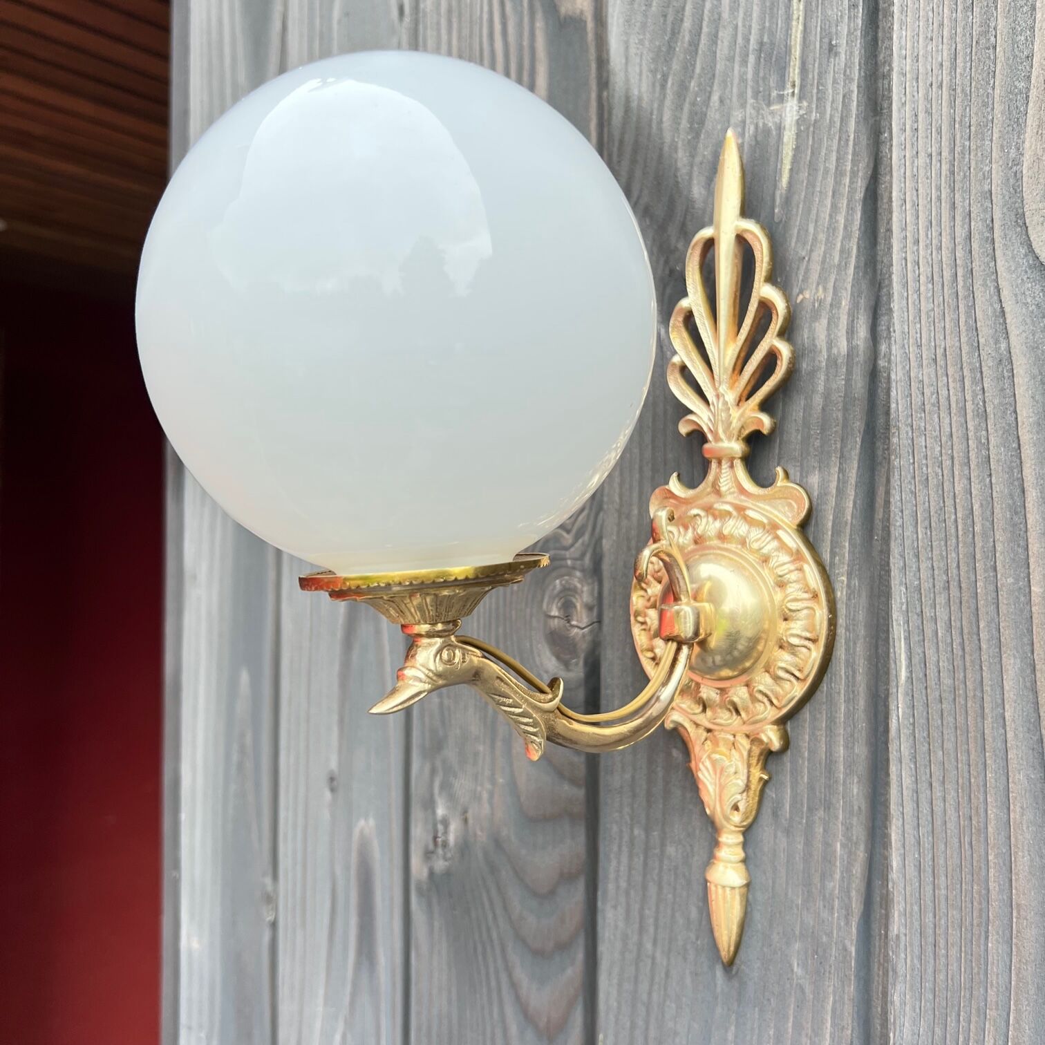 Brass "bird" wall lamp and opal globe