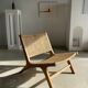 Reclining armchair in natural wood and woven rattan