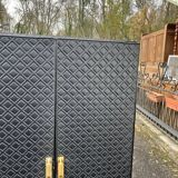 Contemporary wardrobe in black faux leather with diamond pattern and gold handles.