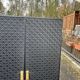 Contemporary wardrobe in black faux leather with diamond pattern and gold handles.