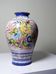 Vintage Portuguese vase in glazed terracotta with hand-painted floral decoration.