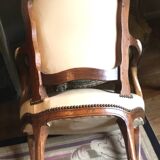 Louis XV period armchair in natural wood with convertible back carved with flowers