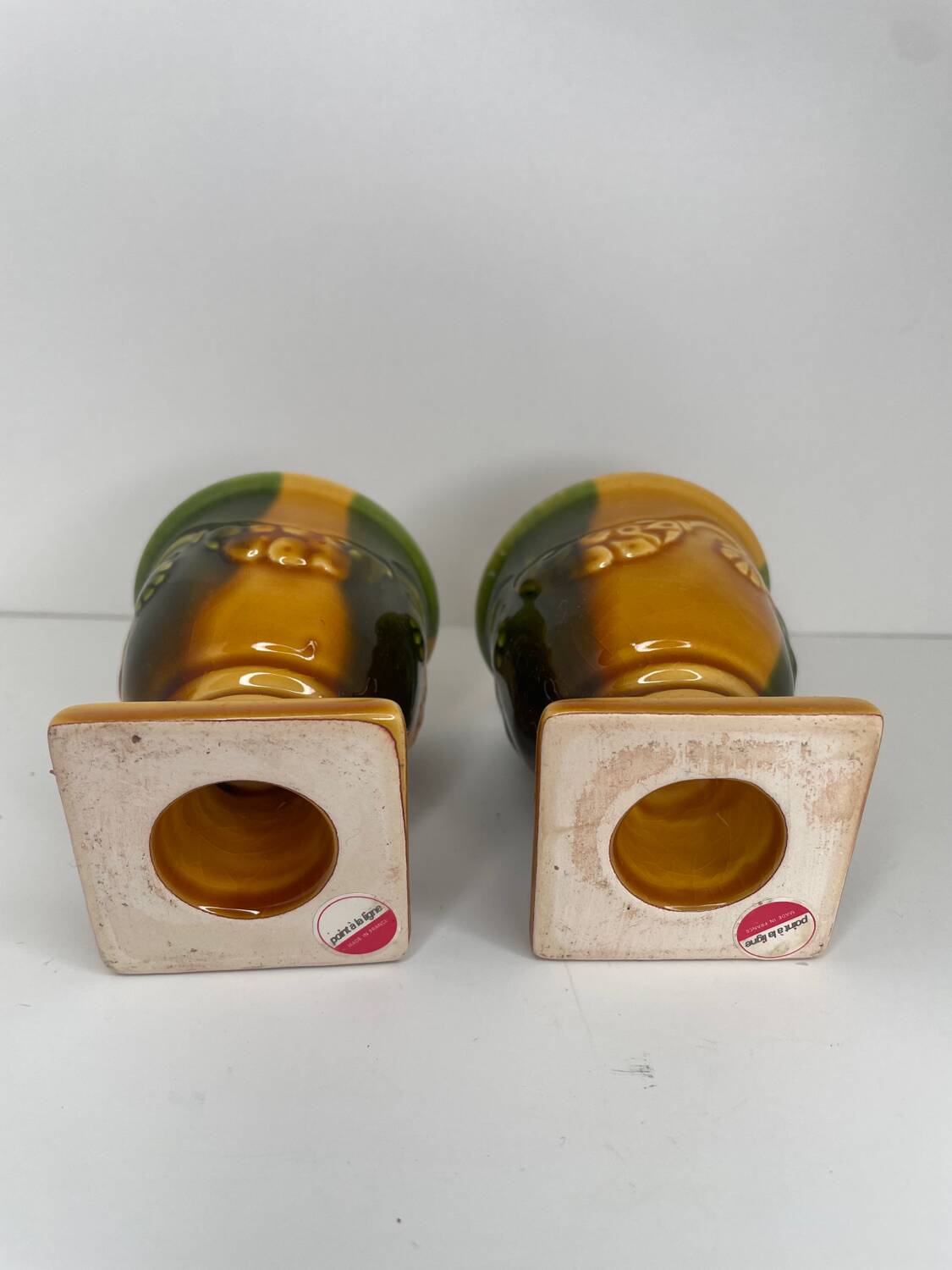 Pair of ocher and green ceramic point-a-line candlesticks