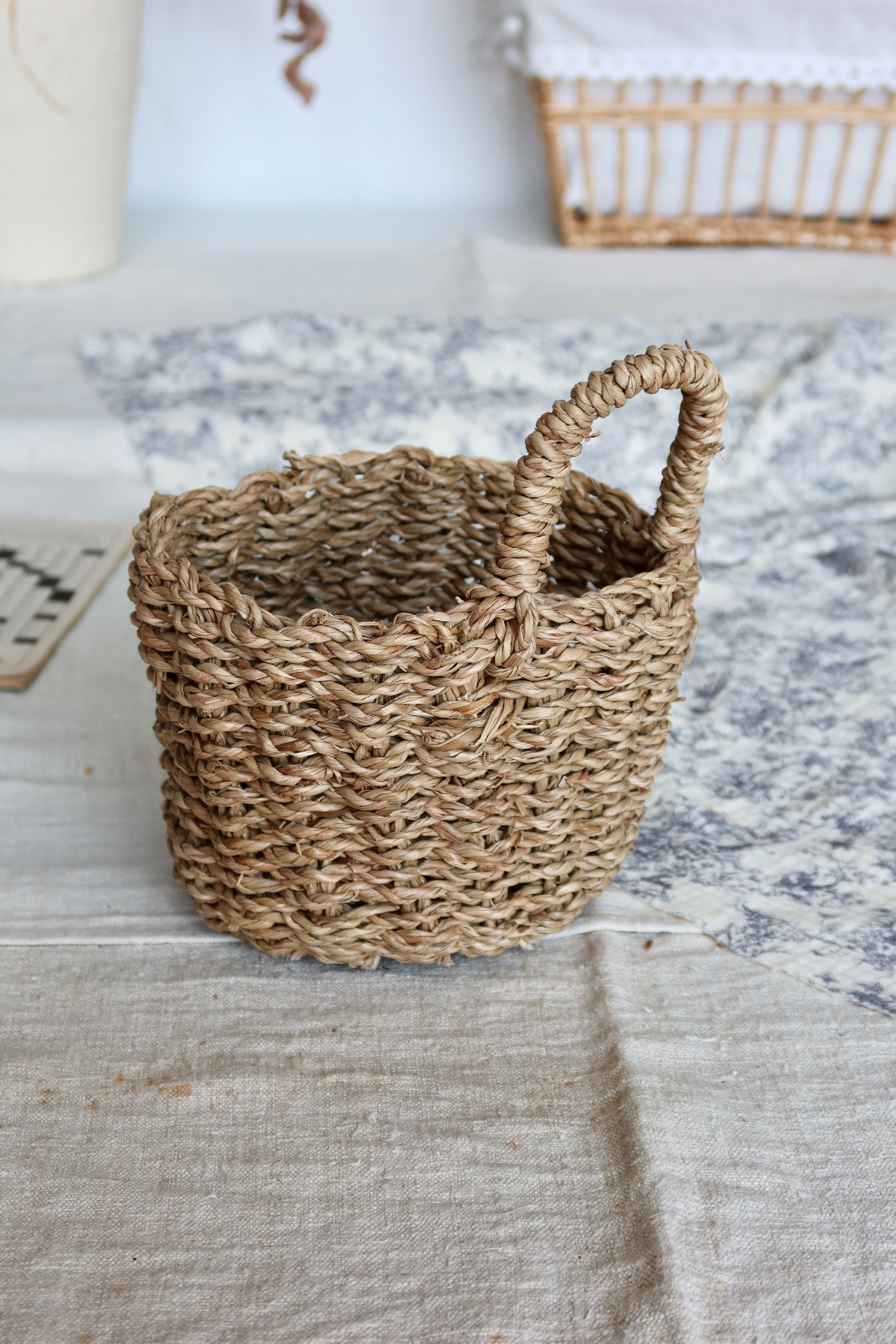 Small vintage woven fiber wall basket with handle