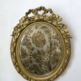 Miroir ancien ovale doré – style Louis XVI avec nœud ruban