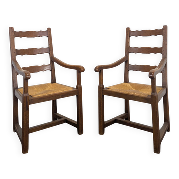 Pair of rustic oak armchairs with straw seats