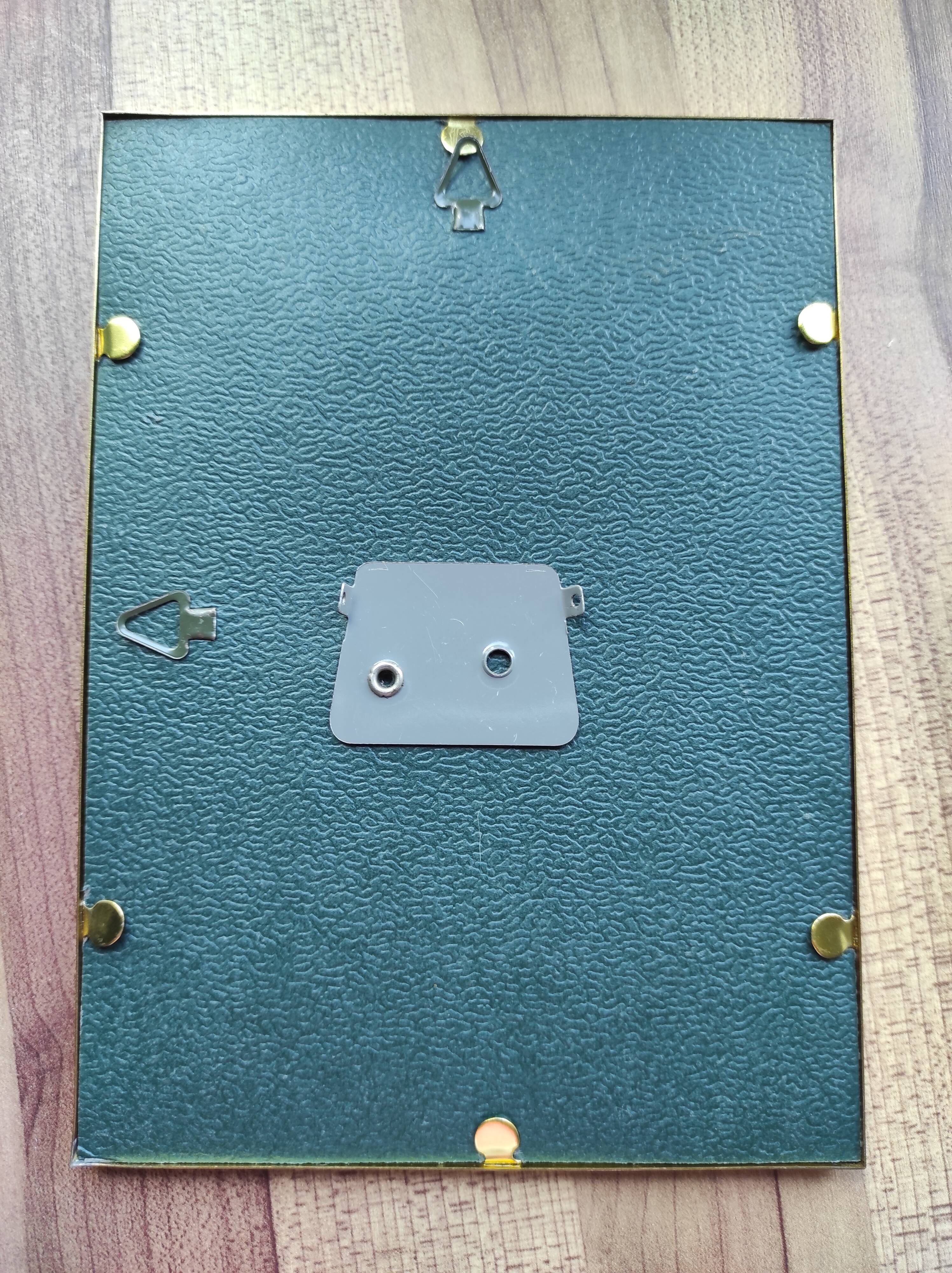 Vintage photo frame in gold and decorated metal