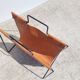 Magazine rack in tan leather and black metal