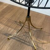 Designer floor lamp in black lacquered metal and brass, incorporating a magazine rack