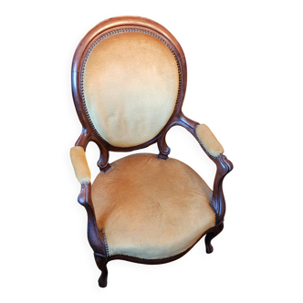 Antique cabriolet armchair in Louis Philippe medallion style.