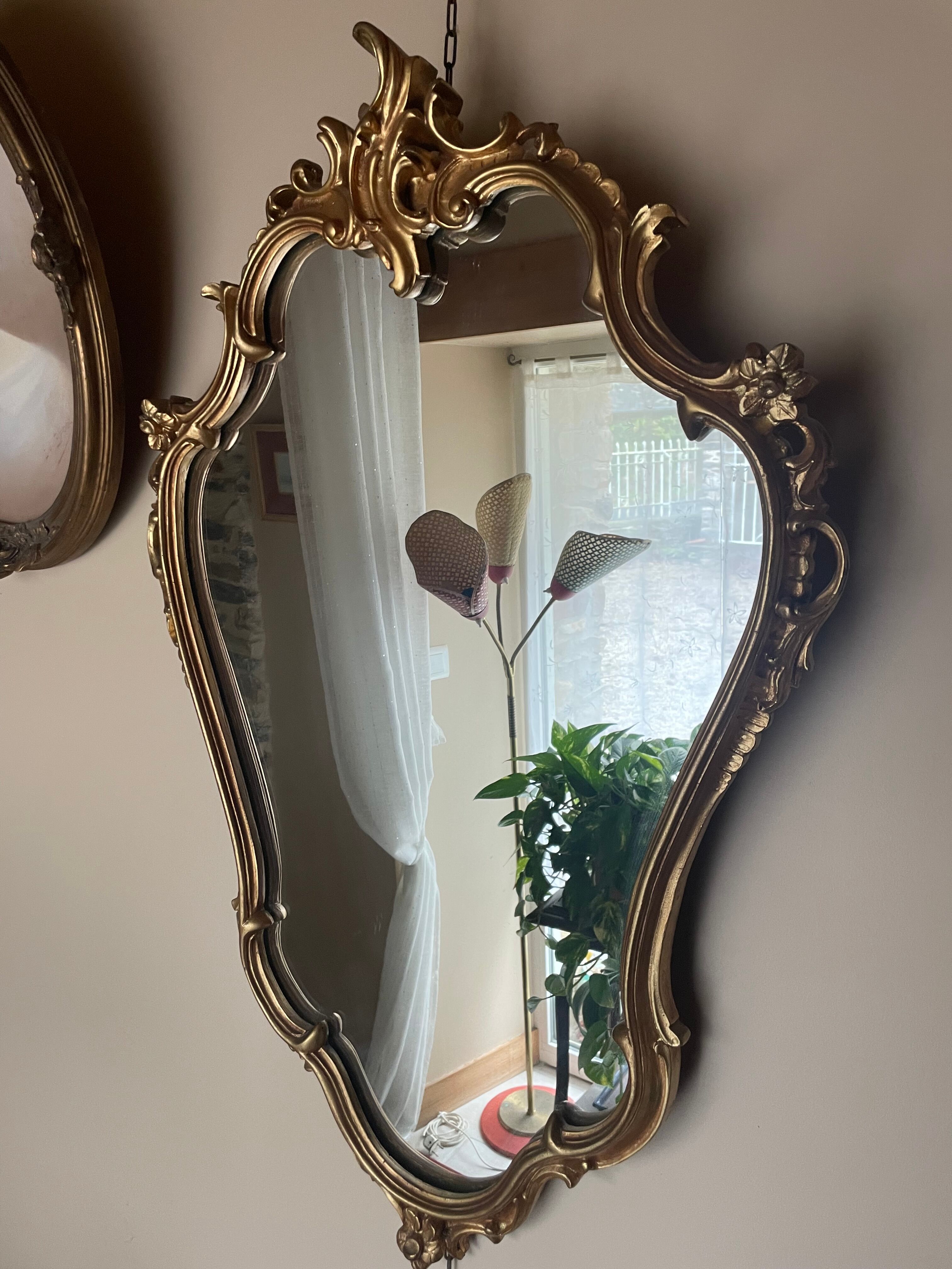 Louis XV Style wood and gilded stucco mirror with animated shape