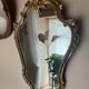 Louis XV Style wood and gilded stucco mirror with animated shape