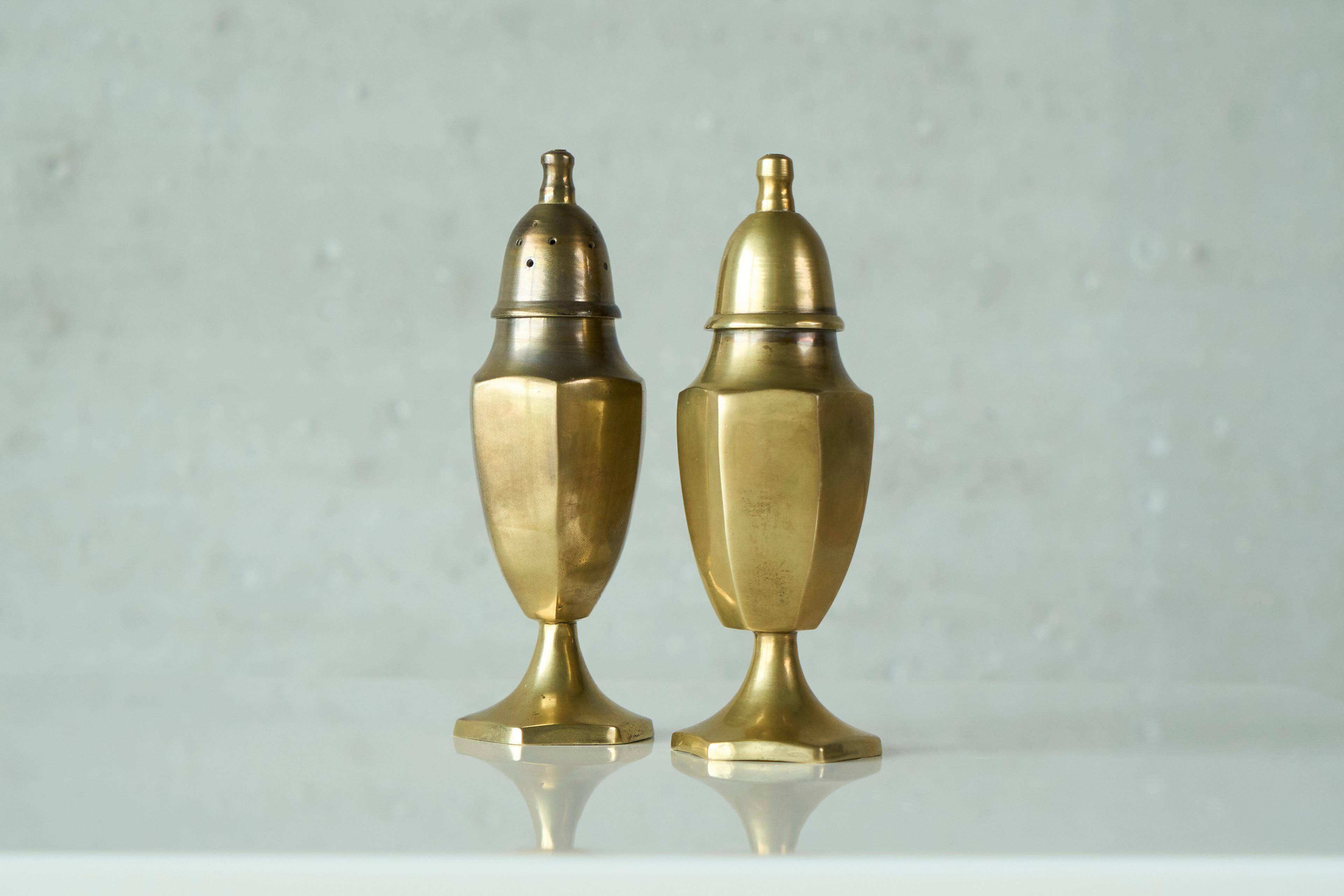 Pair of patinated brass salt and pepper shakers, 20th century.