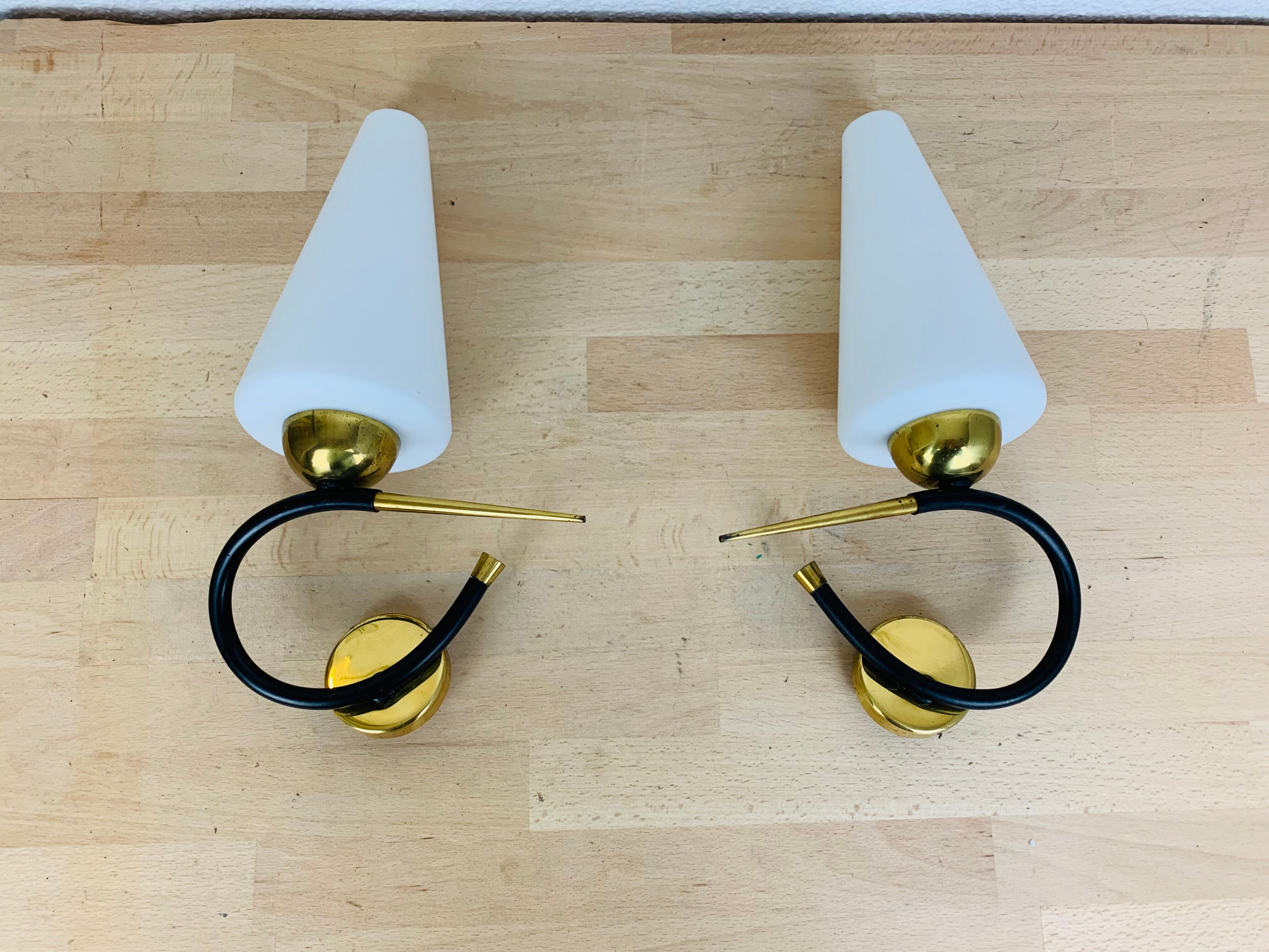 Pair of Arlus 50s opaline black and golden brass wall lamps