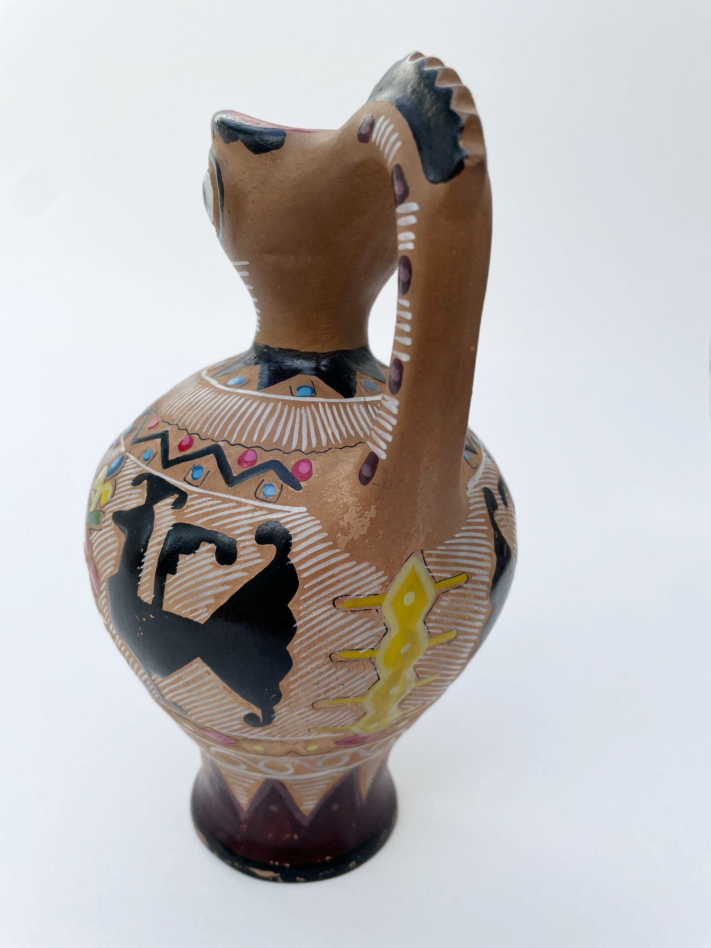 Clay pitcher with a bird head