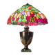antique patinated cast iron lamp with a glass paste lampshade, showing signs of wear.