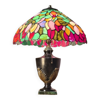 antique patinated cast iron lamp with a glass paste lampshade, showing signs of wear.
