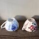 A set of 2 Digoin Sarreguemines cups with pink and blue flowers.