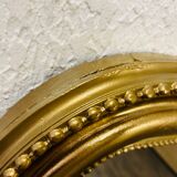 Antique gilded mirror in old Louis Philippe wood