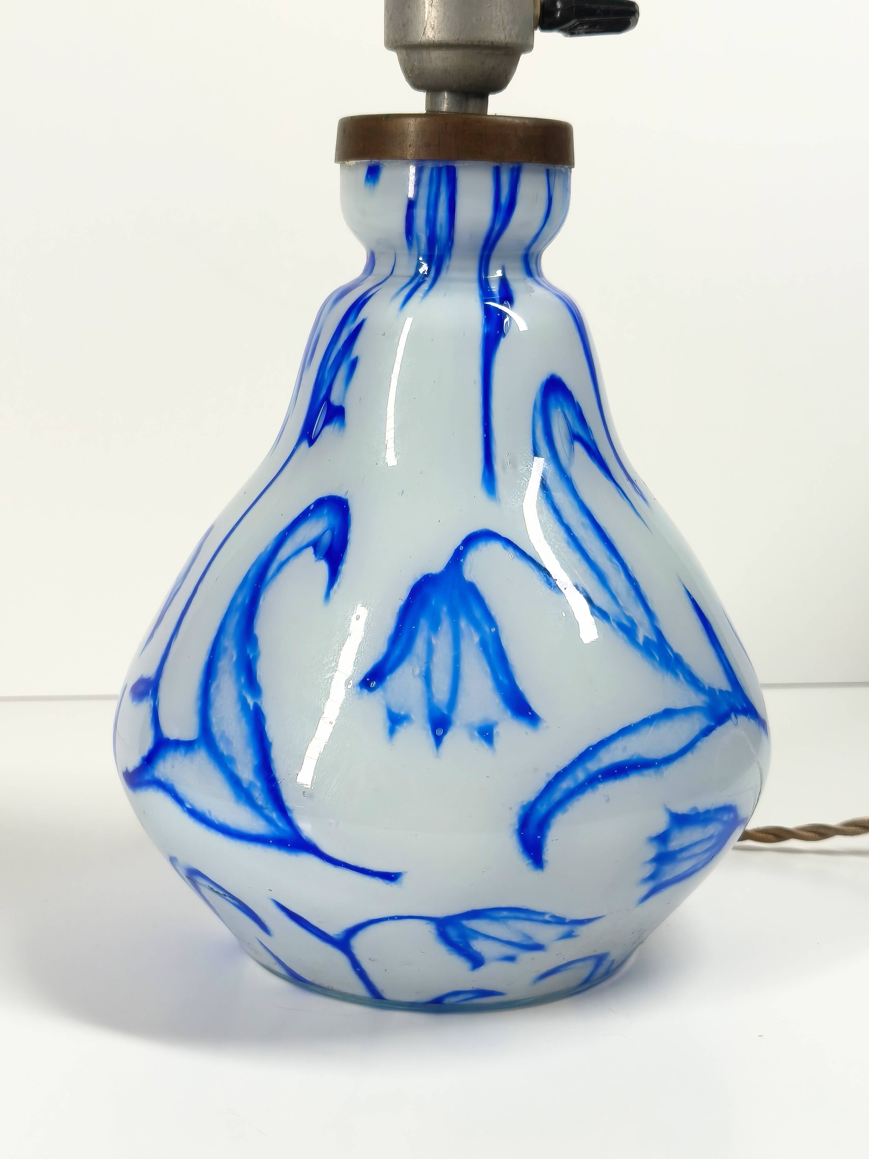 Antique table lamp in opaline glass with blue floral decoration.
