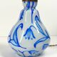 Antique table lamp in opaline glass with blue floral decoration.