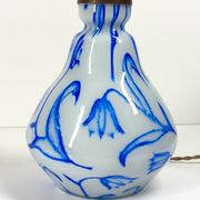 Antique table lamp in opaline glass with blue floral decoration.