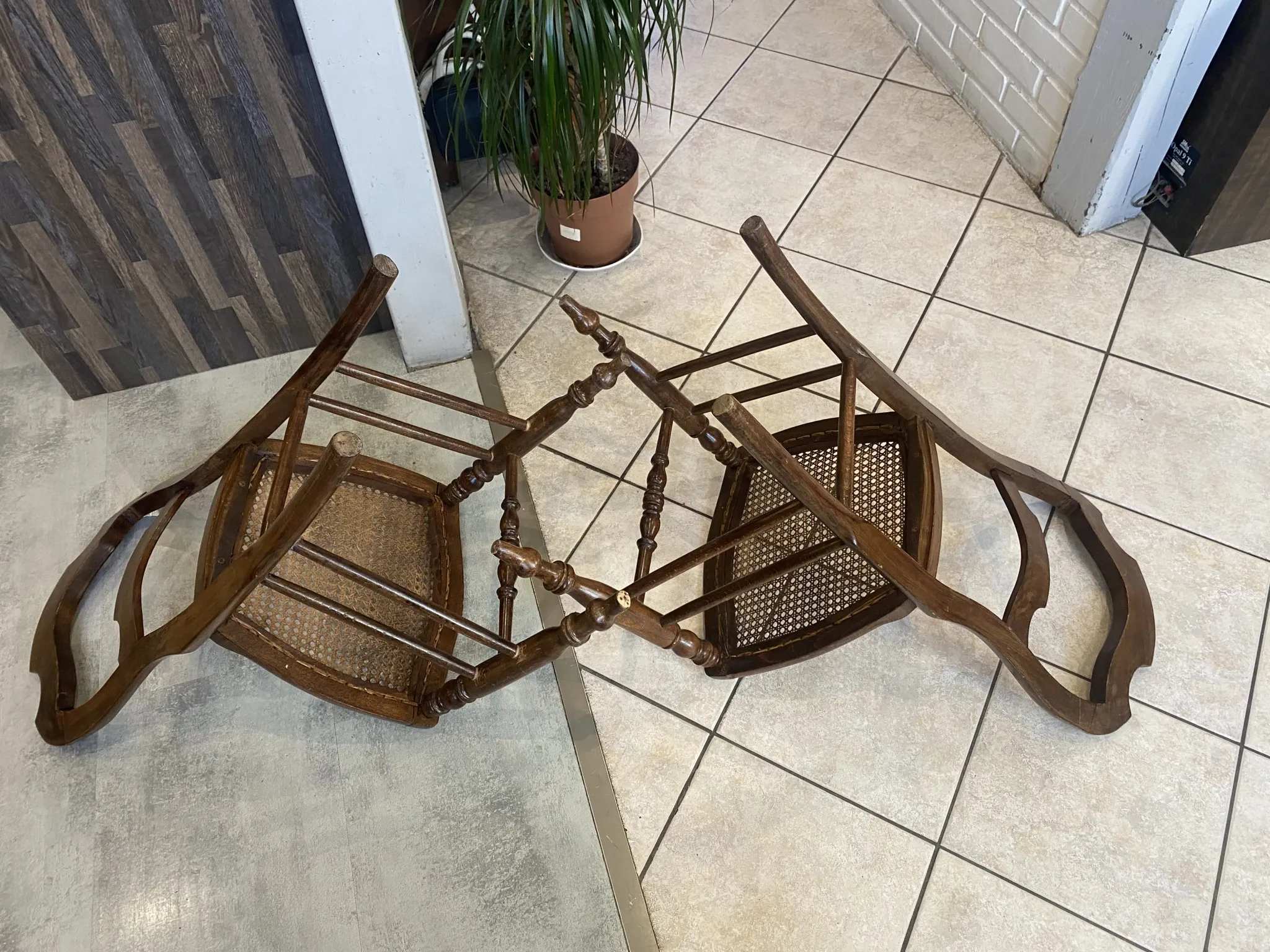 Pair of antique caned and wooden chairs from the 1900s.