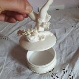 Small round box topped with a vintage biscuit porcelain angel