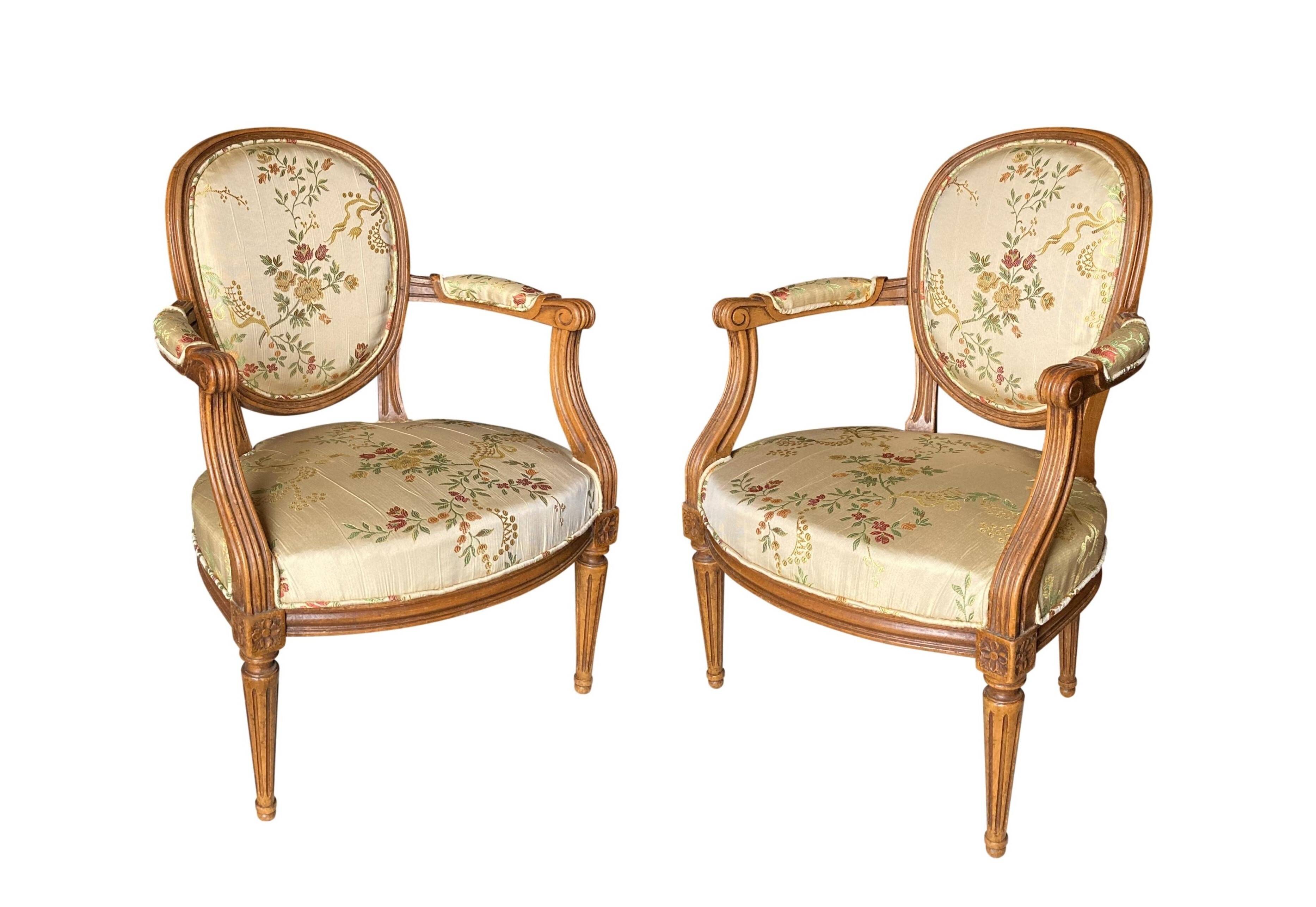 Pair of Louis XVI silk cabriolet armchairs