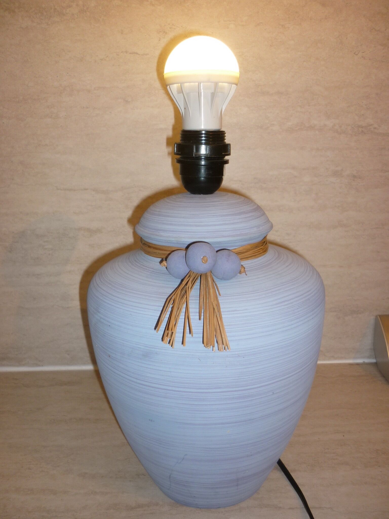 Vintage ceramic lamp foot with ball necklace and raffia.